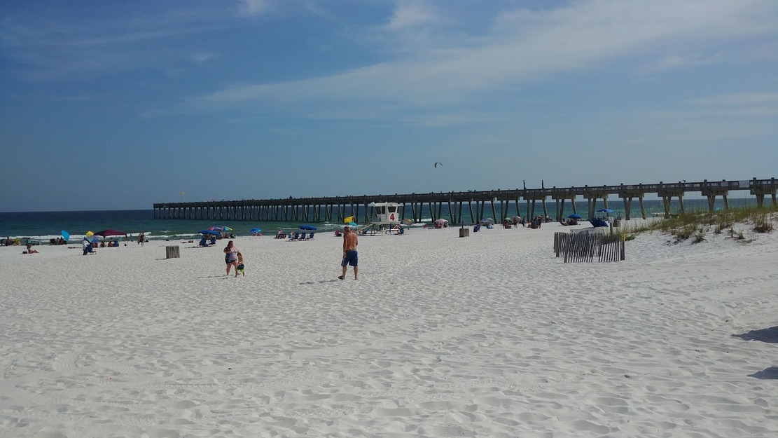 Sandy beach with a fishing pier