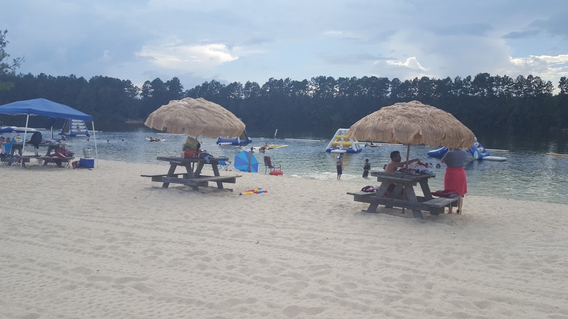 Thatched umbrellas on White Sands Lake Day Beach