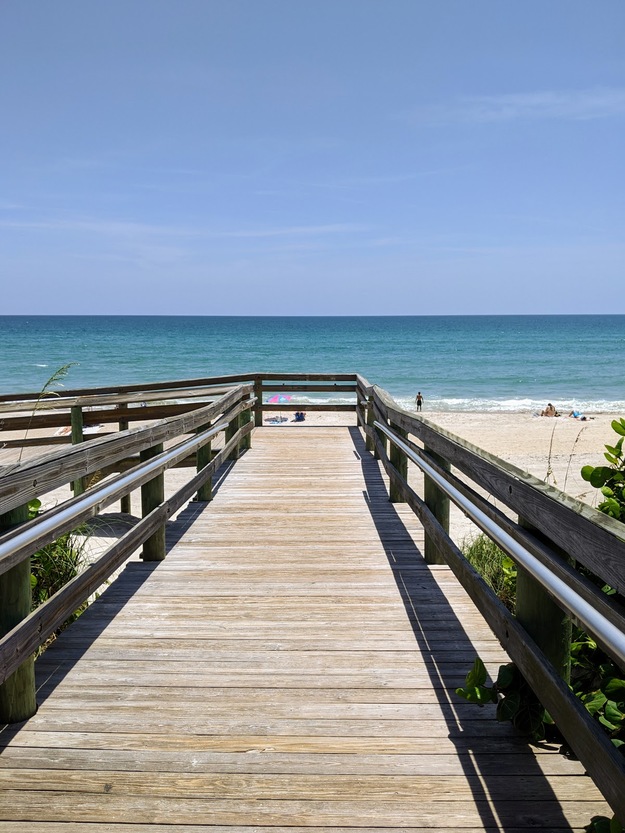 Wooden boardwalk on Coconut Point Park Beach