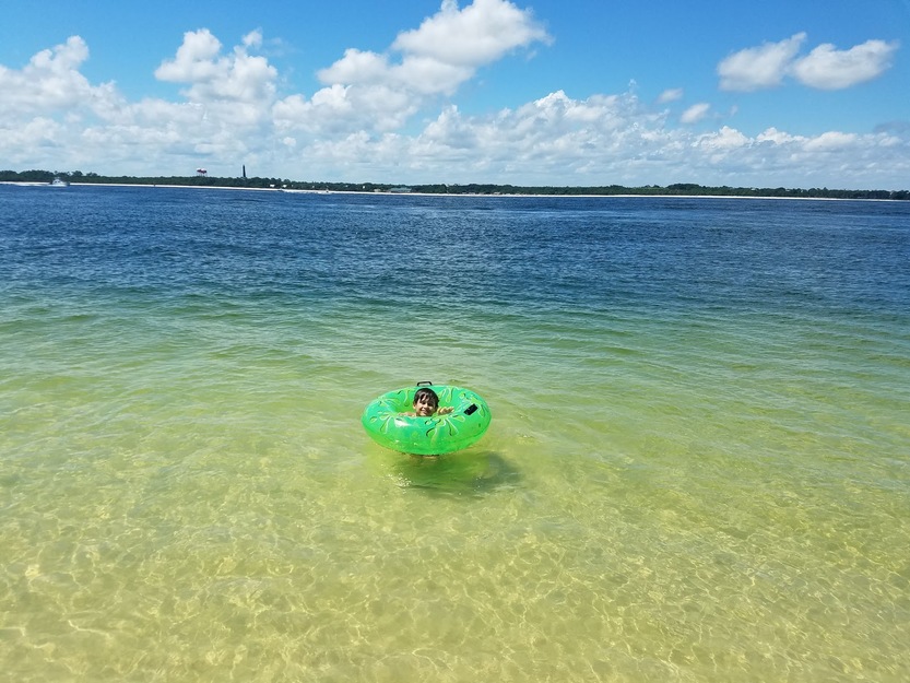 Child swimming at Fort Pickens Beach, FL