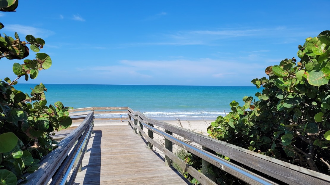 Wooden boardwalk leading to Coconut Point Park Beach FL