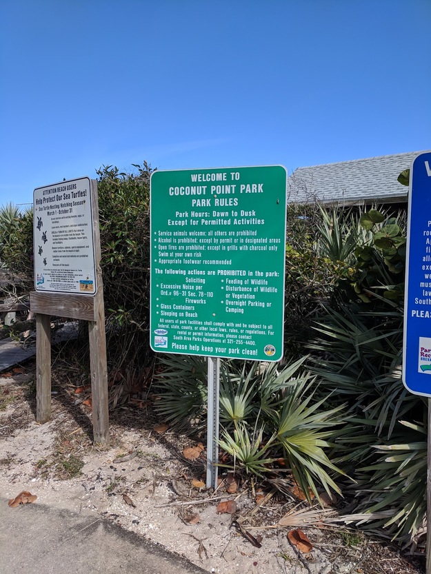 Information shield on Coconut Point Park Beach FL