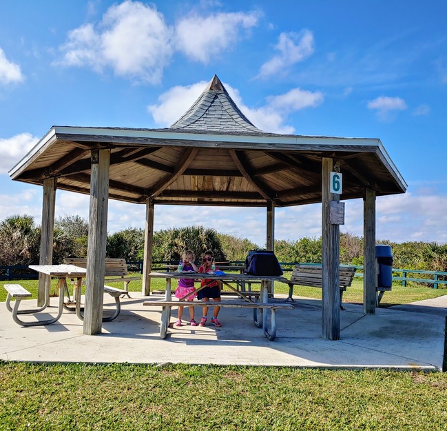 Shaded tables on Michael Crotty Bicentennial Park Beach FL