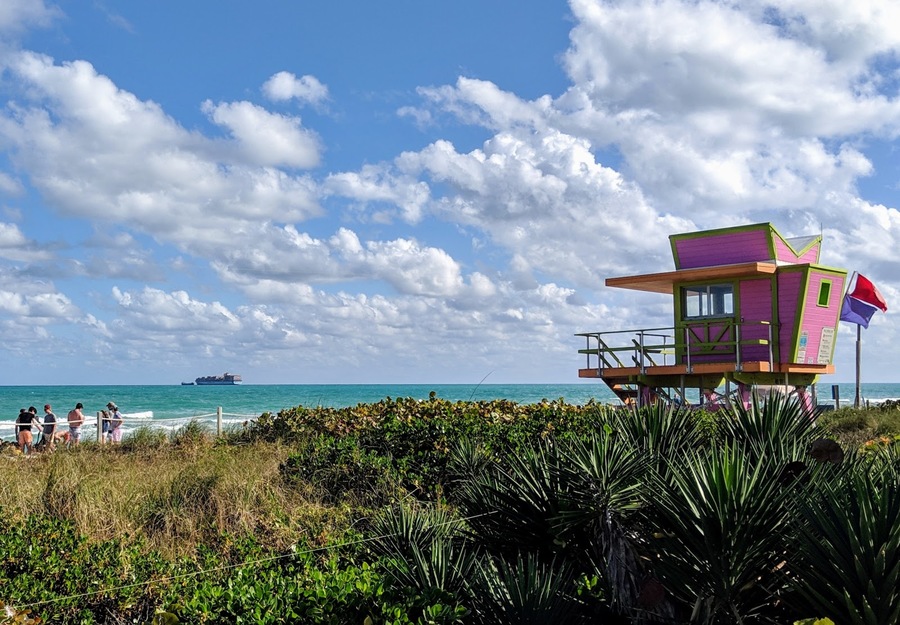 Pink lifeguard station on a grassy seashore