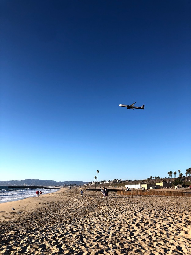 Plane flying over Dockweiler Beach California