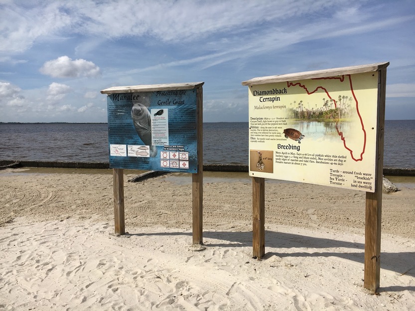 Information shields on Alfred McKethan Pine Island Park Beach