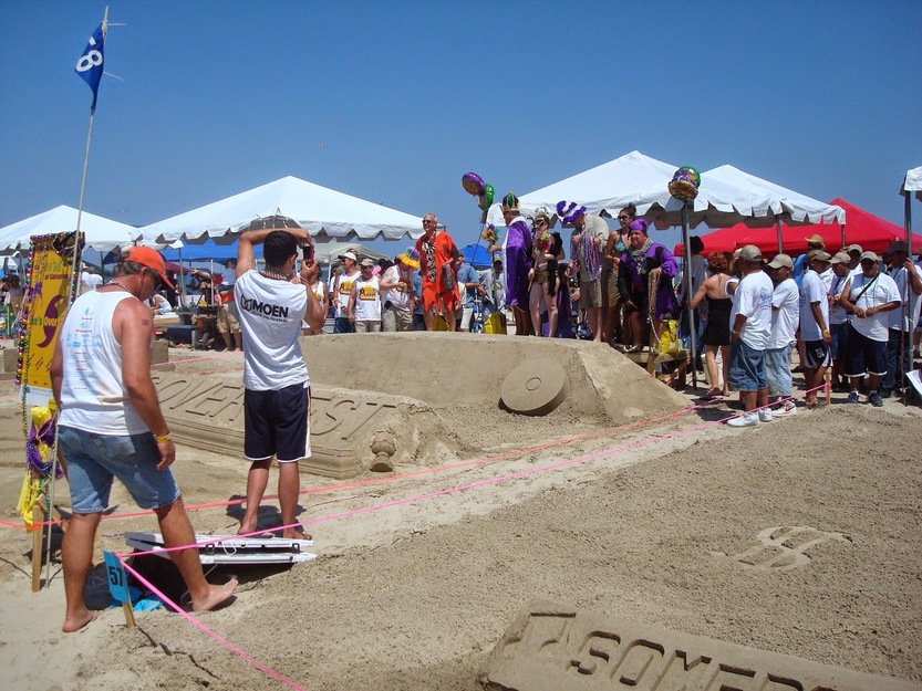 People watching sand figures