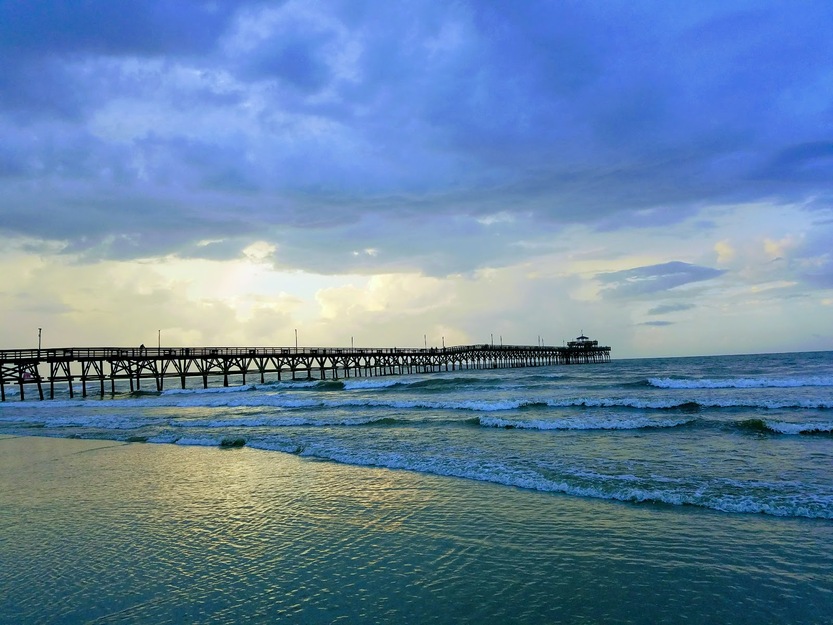 Heavy clouds over the sea and over the pier