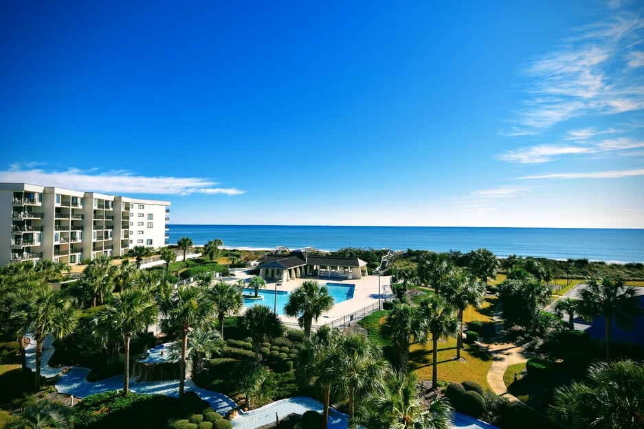 Hotal and palms on the seashore
