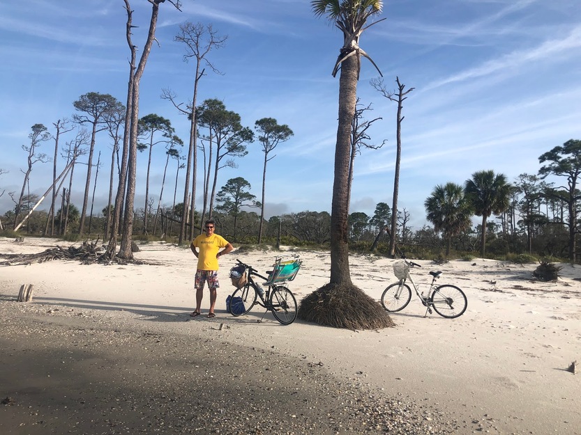Man with two bikes on St. Vincent National Wildlife Refuge Beach
