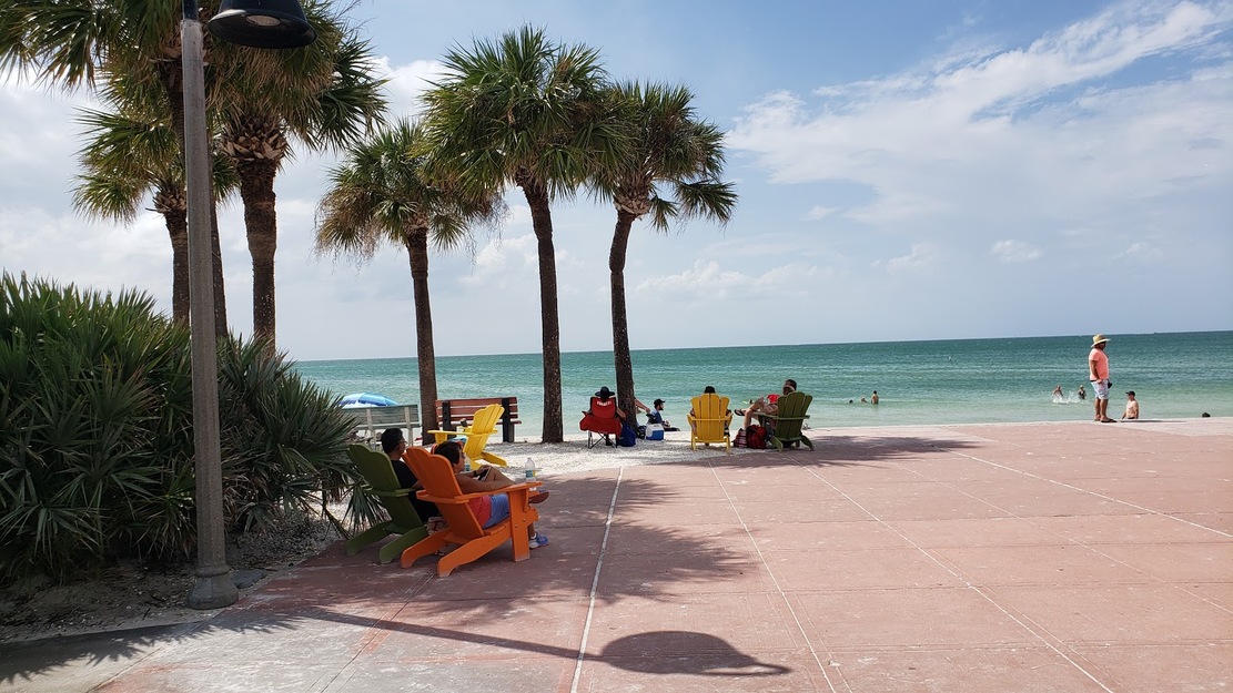 Holiday makers relaxing under beach palms