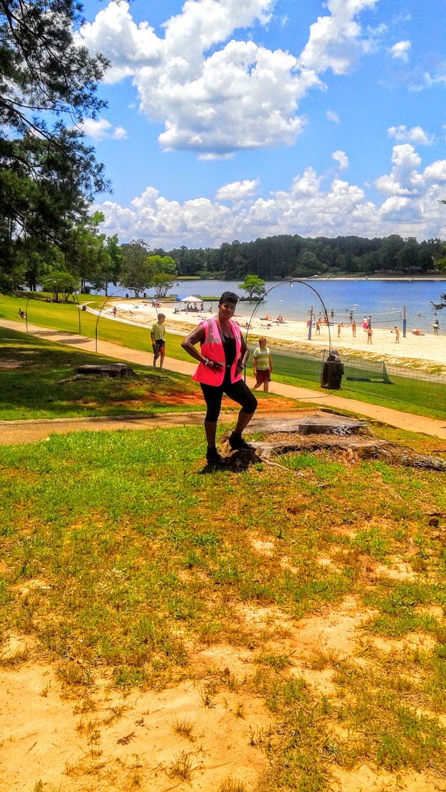 Woman standing on the grass near the beach